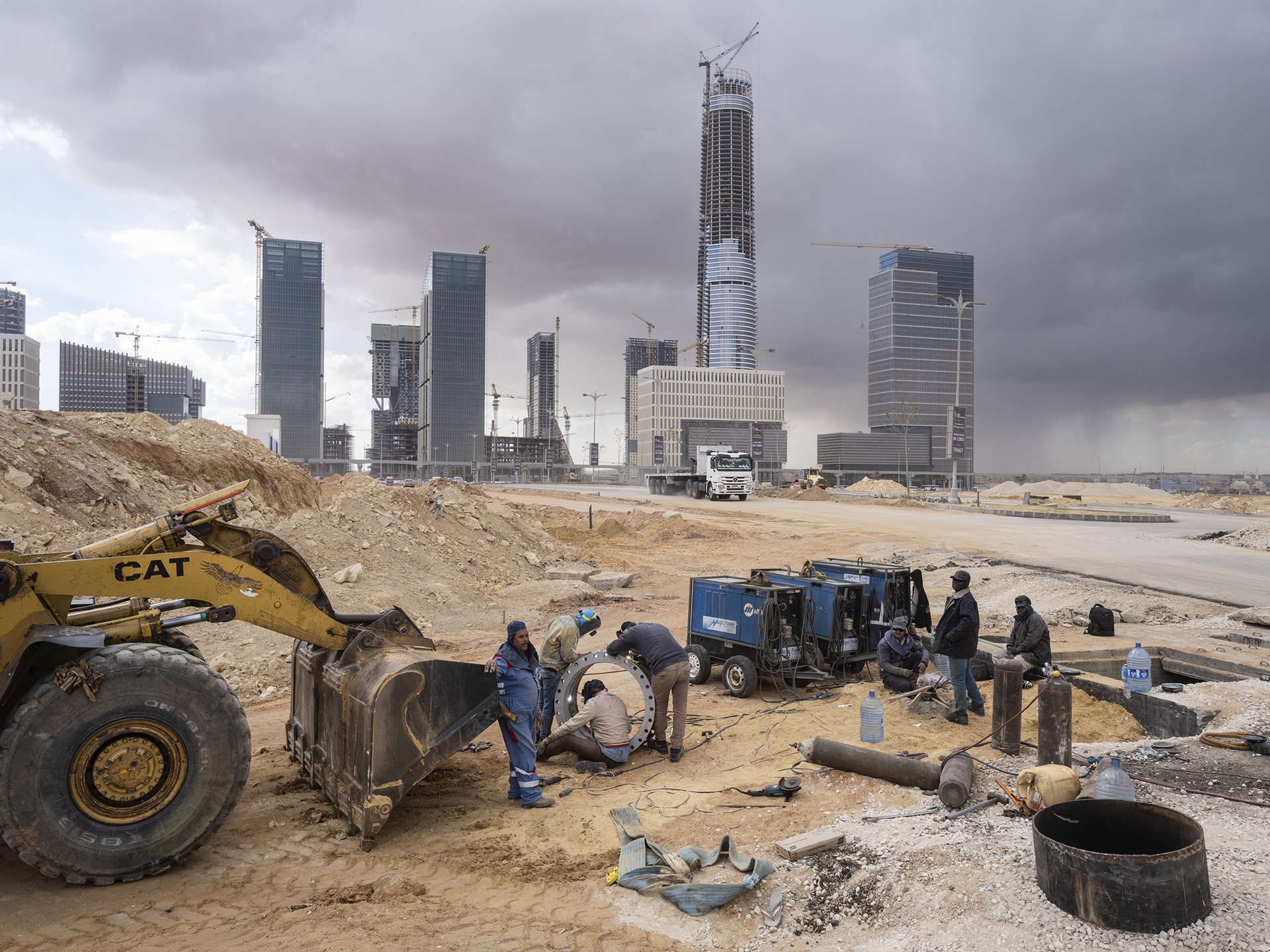 <p>Welders work near the future Central Business District of Egypt's New Administrative Capital, under construction near Cairo. The Iconic Tower (center) will be Africa&rsquo;s tallest building, at 394 meters high.</p>
