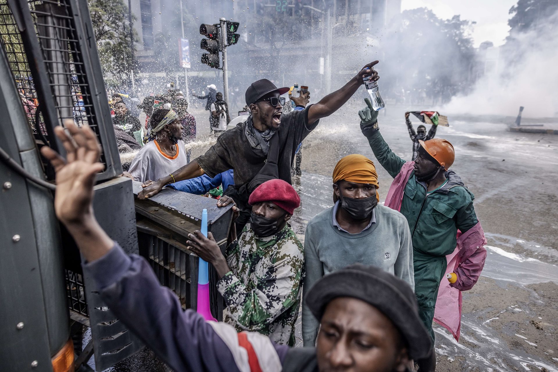 Protestors chant anti-government slogans while climbing a Kenya Police water cannon truck during a nationwide protest against tax hikes and the Finance Bill 2024 in Nairobi, Kenya.