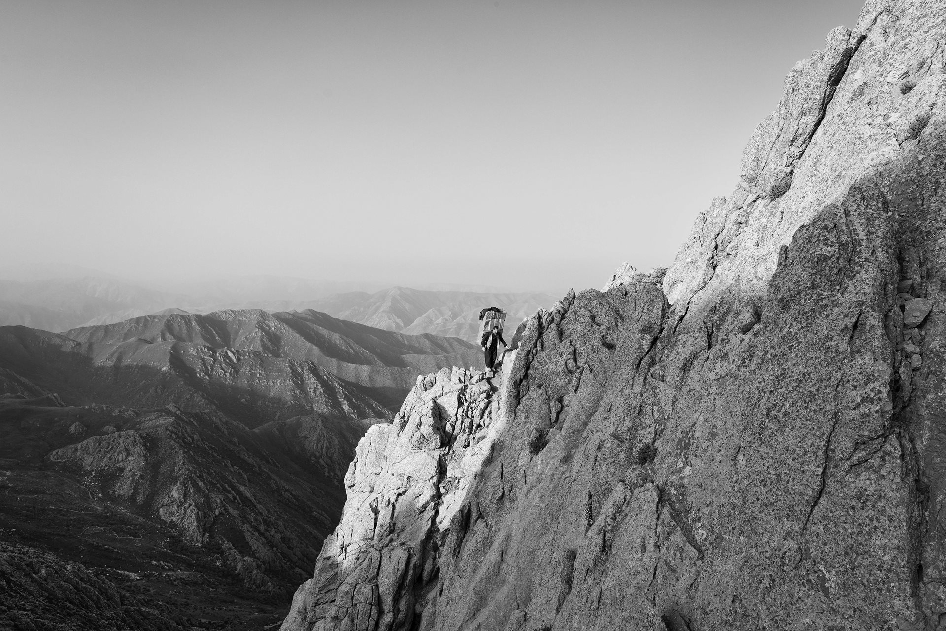 A kolbar follows an arduous mountain path, in Kurdistan, Iran.